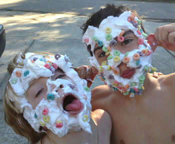 Man playing child's game with whipped cream on face Stock Photo